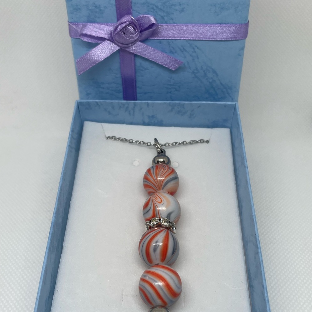 Exquisite Silver & Orange Swirl Necklace
Expertly Handcrafted, Exclusively Yours